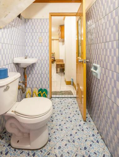 a bathroom with a toilet and a sink at CJ&K Baguio Lodge in Baguio
