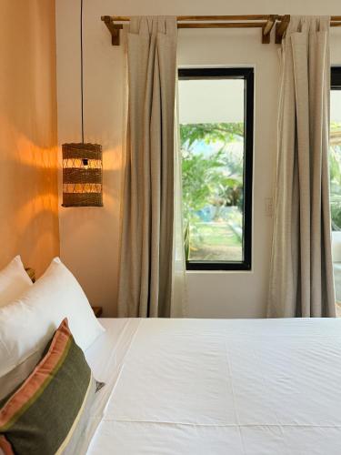 a bedroom with a bed and a window at Casa Zala in El Paredón Buena Vista