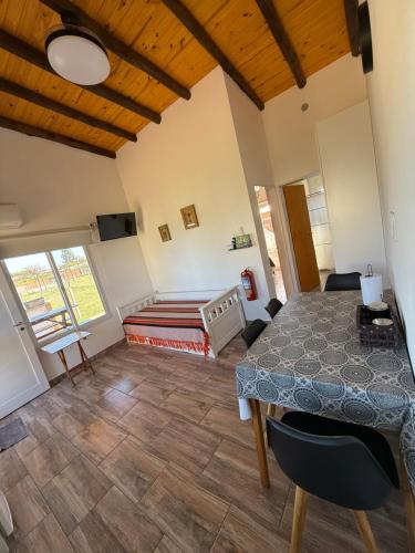 a bedroom with a table and a bed in a room at Complejo Aires del Cielo in San José