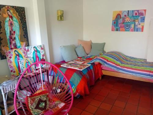 a small room with a bed and a fan at Valeria del Mar Apartment in Valeria del Mar