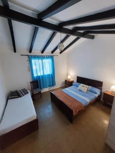 a large bedroom with a bed and a window at Casa Paraiso Serrano in Valle Hermoso