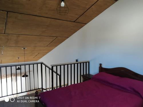 a bedroom with a bed with purple sheets at Departamentos Necochea in Necochea