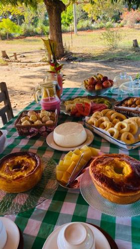 een picknicktafel met brood en gebak erop bij Pousada Portal do Peruaçu in Januária