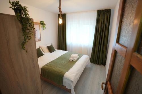 a bedroom with a bed with a stuffed animal on it at Apartament la munte in Topliţa