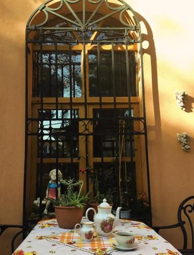 a table with a teapot and a tea pot on it at Anthea Butik Otel in Adalar