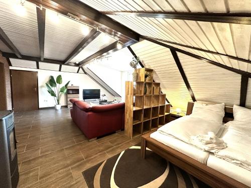 a bedroom with a bed and a chair in a room at LUMI Living in Schlüsselfeld
