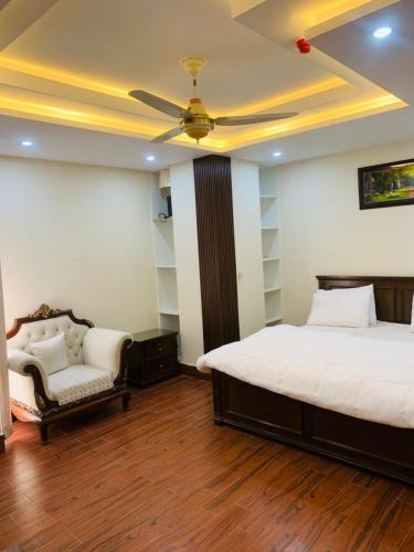 a bedroom with a bed and a ceiling fan at Pavilion 99 Serenity Appartment 2bhk in Rawalpindi