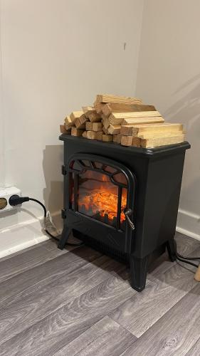 a black fireplace with logs on top of it at Solgården in Falkenberg