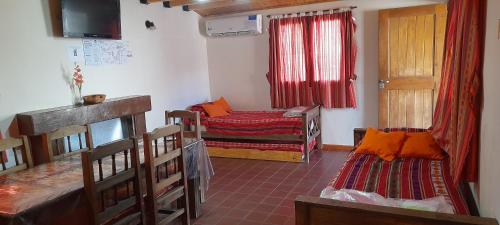 a small room with two beds and a window at Cabañas Soledad in Potrerillos