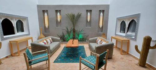 a living room with two couches and a table at Hôtel Riad La Nouvelle Etoile - Agadir in Agadir