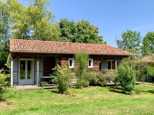 a small house with a porch and a yard at ZEcamping 3 étoiles animaux acceptés piscine snack bar et restaurant in Moutiers-sous-Chantemerle