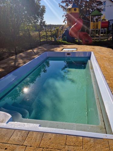 a swimming pool with a slide and a playground at Willa Nemo in Karwia