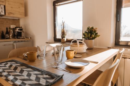 a wooden table with a table cloth on top of it at Apartma Castrum Vini in Ajdovščina