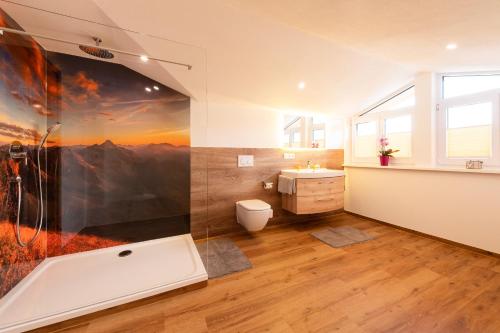 a bathroom with a large painting on the wall at Haus Aigner in Fischen