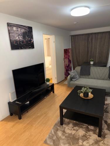 a living room with a couch and a flat screen tv at Modern Oslo Studio Near Aker Brygge in Oslo