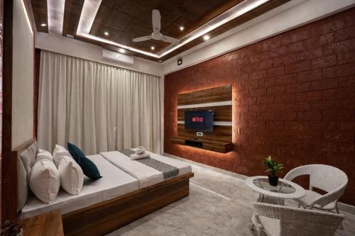a bedroom with a bed and a brick wall at Selborne Villas in Nagothna