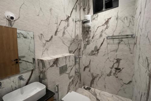 a bathroom with a toilet and a sink at Selborne Villas in Nagothna