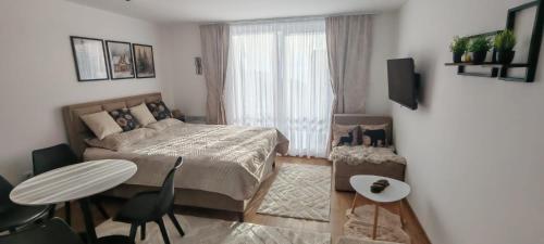 a bedroom with a bed and a table and chairs at Kopaonik Alibi25 in Kopaonik
