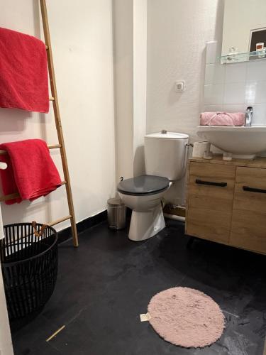 a bathroom with a toilet and a sink at Le cocon de Lilo et Stitch in Montereau-Fault-Yonne