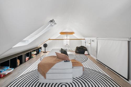 a living room with a white couch and a rug at Duplex Rooftop at MIT Kendall Sq - 2 FREE Parking in Cambridge