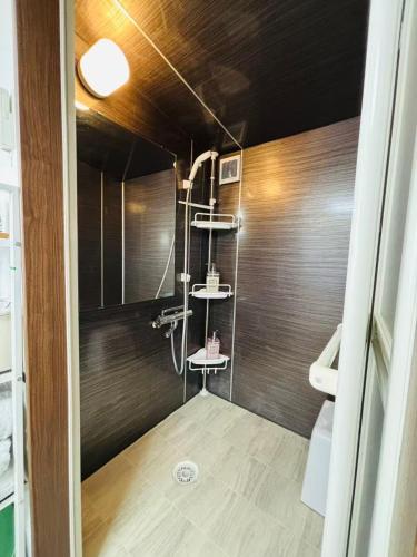 a bathroom with a shower with a toilet in it at Shimokitazawa Cozy Apartment 401 in Tokyo
