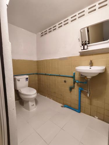 a bathroom with a toilet and a sink at SridaHouse#Near Central Festival Hat Yai in Sathani Khlong Rian