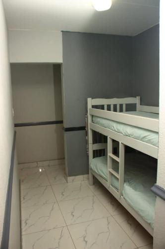a small room with two bunk beds in it at Unit 35 Pendleberry grove holidays in Bela-Bela