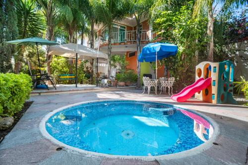 a small swimming pool with a slide and a playground at Villa a 10 mins de Tx 5 habs 6 baños jacuzzi brincolín in Tequisquiapan