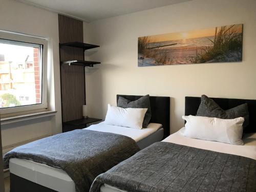 a hotel room with two beds and a window at Meckenheim in Meckenheim