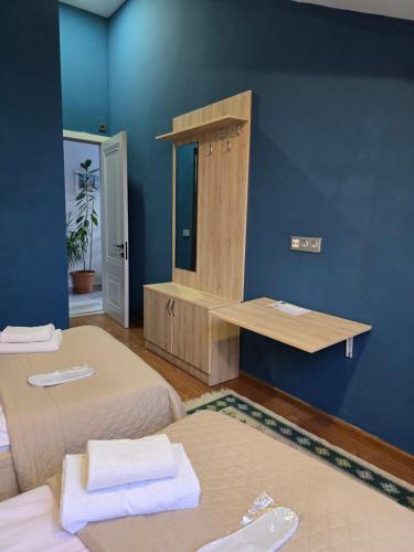 a room with two beds and a blue wall at Favourite in Sighnaghi