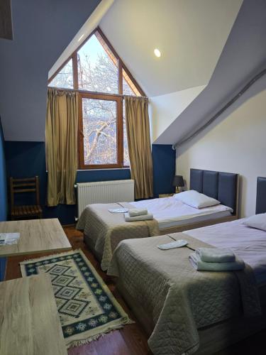 a bedroom with two beds and a window at Favourite in Sighnaghi