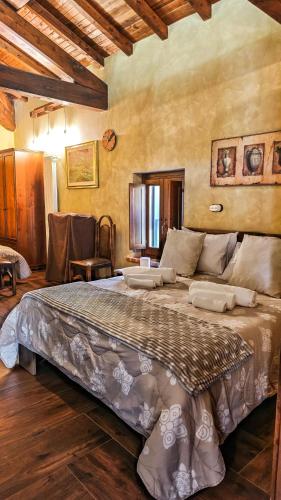 a bedroom with a large bed in a room at Casale Tre Moschetti in Prossedi