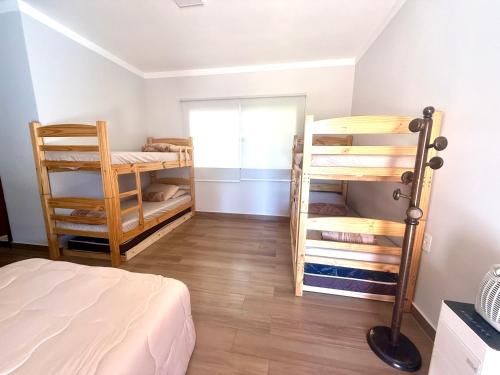 a bedroom with bunk beds and a room with a bed at A Casinha in Socorro
