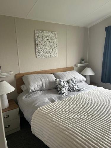 a bedroom with a bed with two pillows on it at Ocean view in Heysham