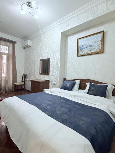 una camera da letto con un letto grande con una coperta blu di Republic Square 2 bedroom 2 bathroom a Yerevan