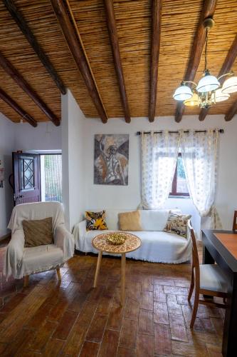 a living room with a couch and a table at Cantinho Alentejano-Rua das Hortas, Corte Pao e Agua in Mértola