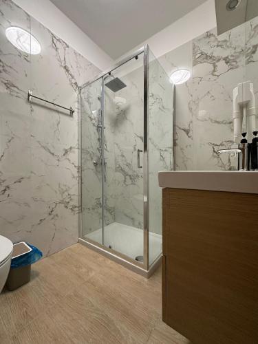 a bathroom with a shower with a glass door at Venice Night 11 in Mestre