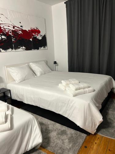 a bedroom with two beds with white sheets at Estudio en Sol (G) in Madrid