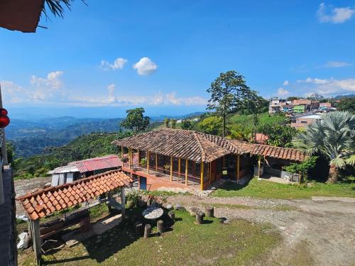 a house with a roof on top of a hill at Perla del Ruiz in Manizales