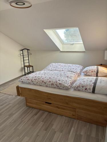 a bed with two pillows on it with a window at Forest Home E&L in Waldshut-Tiengen