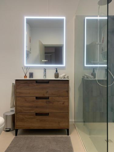 a bathroom with a sink and a mirror at Blue House in Santa Cruz with Sea View in Santa Cruz