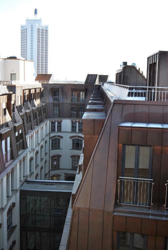 a view of the roofs of buildings in a city at Trafford Sky Homes in Leipzig