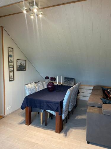a dining room with a blue table and chairs at Vestra-Fíflholt 2 herbergja íbúð, fyrir allt að 8 gesti in Hvolsvöllur