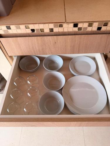 a drawer filled with white dishes in a wooden box at QUINTA BELEN Cañuelas in La Porteña