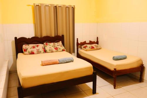 En eller flere senge i et værelse på Casa Ybirá de Alter do Chão