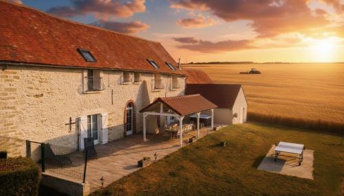 an aerial view of a building with a bench next to it at Domaine des Hirondelles - Escapade de Charme & Spa à 15min de Provins in Champcenest