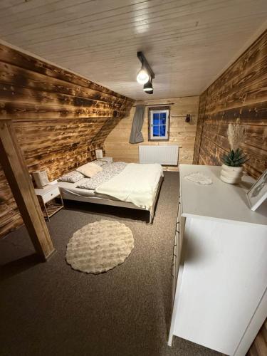 a bedroom with a bed and a table in a room at Chalupa pod jelení skálou in Dolni Dvur
