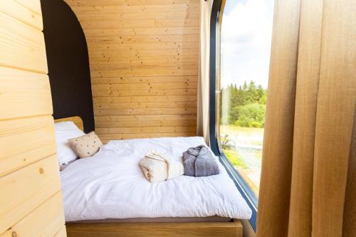 a small bed in a room with a window at Woodydrem in Hruštín