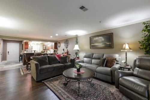 a living room with couches and a table at Comfortable updated Condo with No steps in Branson