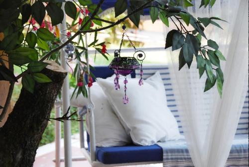 a chair with a pillow and a hanging ornament at Villa Luna Lombarda in Salò